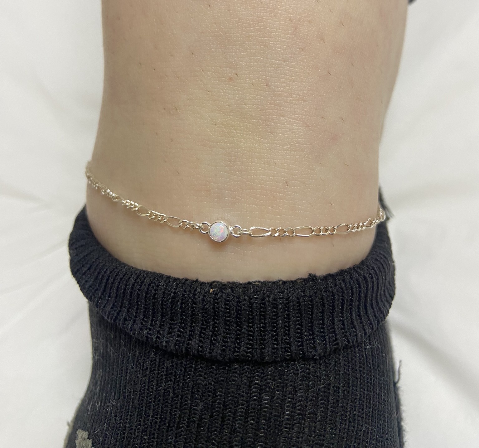 Fitted silver anklet with opal charm by Elessora – permanent jewellery in West Sussex